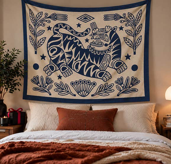 Decorative blue tapestry displayed above a bed